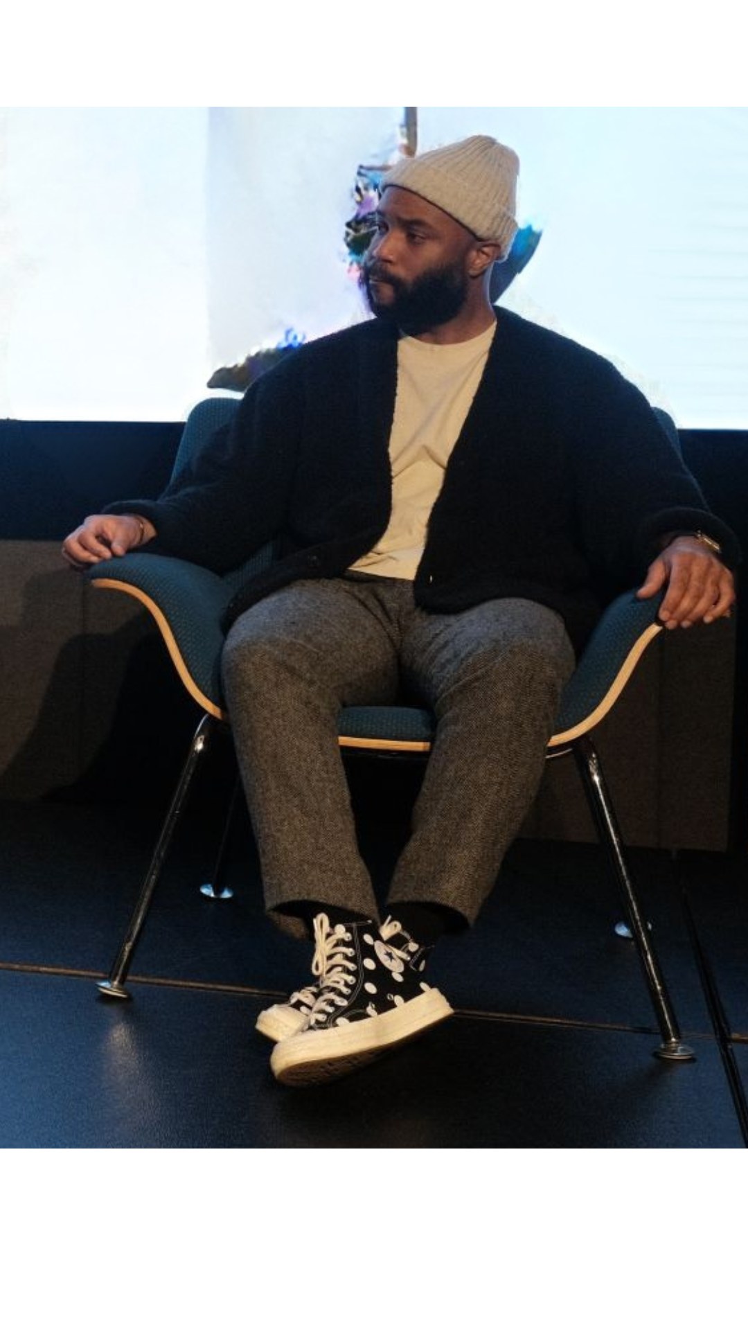 Dr. G seated on stage at a panel